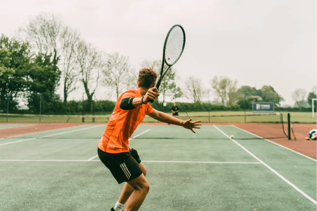 man hitting forehand