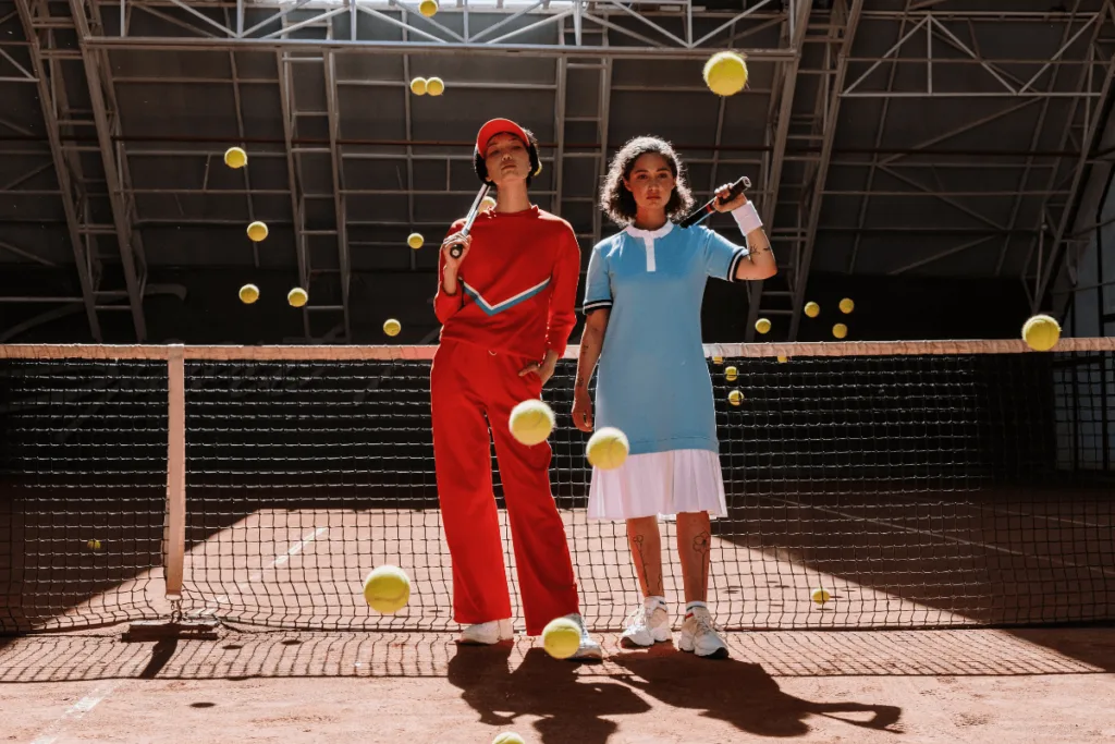 women standing in front of tennis net